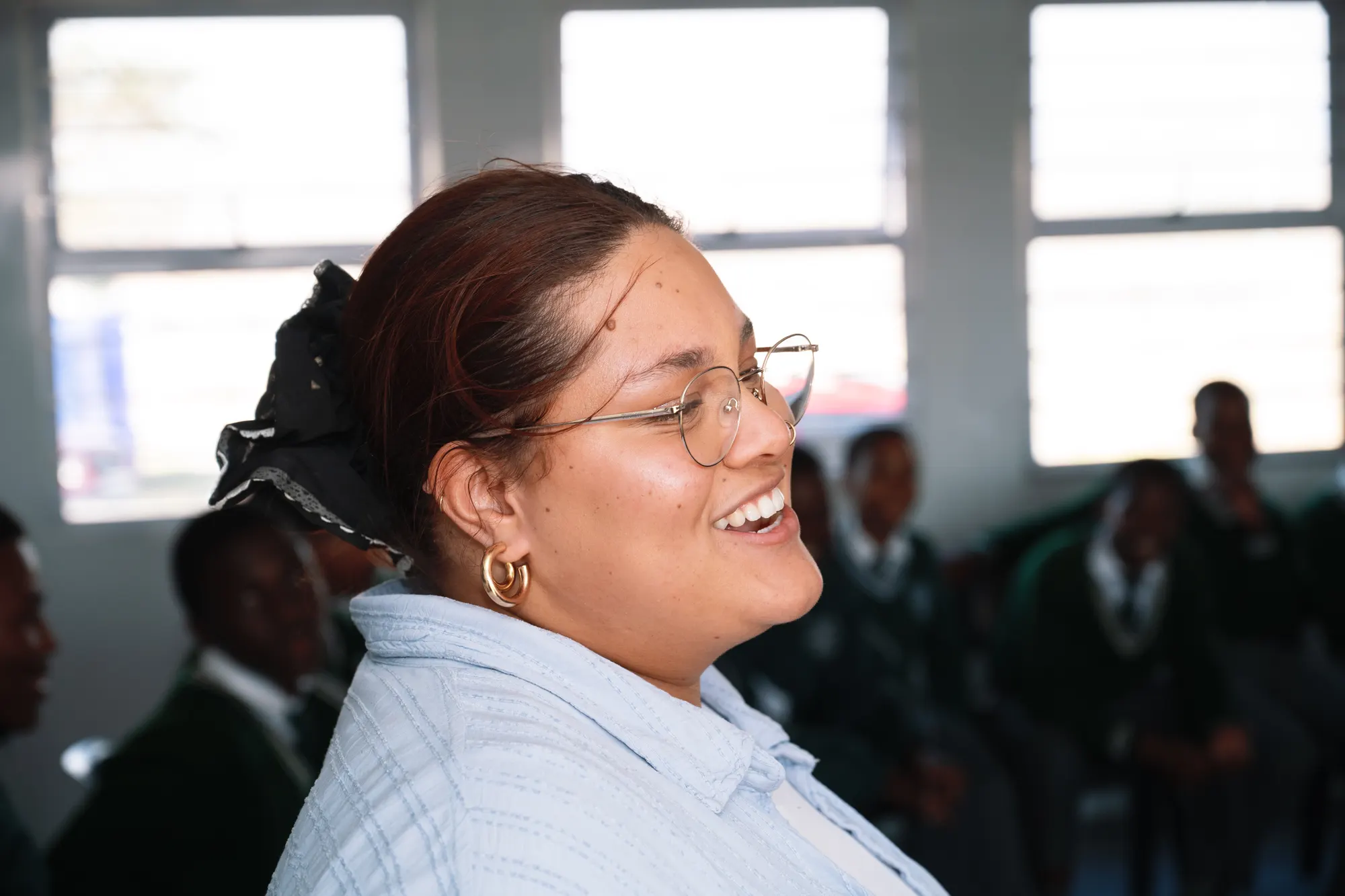 A Phakamani facilitator smiling during a session in a classroom
